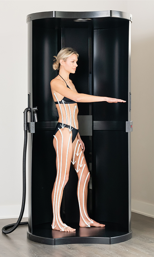 model standing in spray tan booth